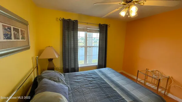 a bedroom with bed and a window