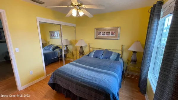 a bedroom with two beds and a chandelier