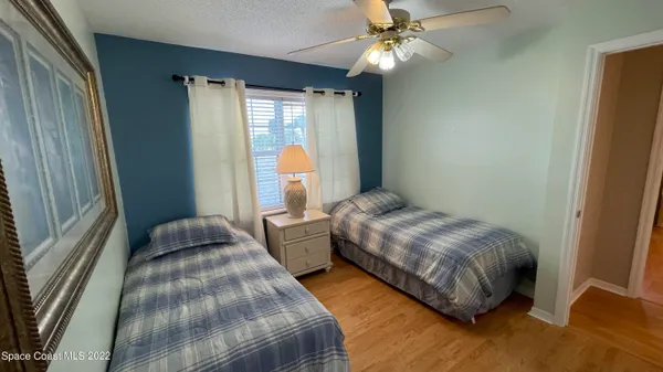 a front view of a house with a yard and potted plants
