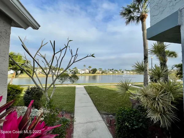 a view of a lake with houses in the back