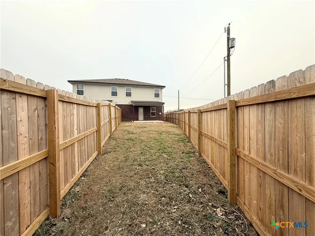 a view of balcony with wooden floor and fence