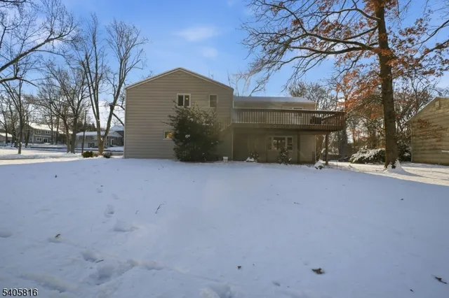 a view of a house with a snow in the yard