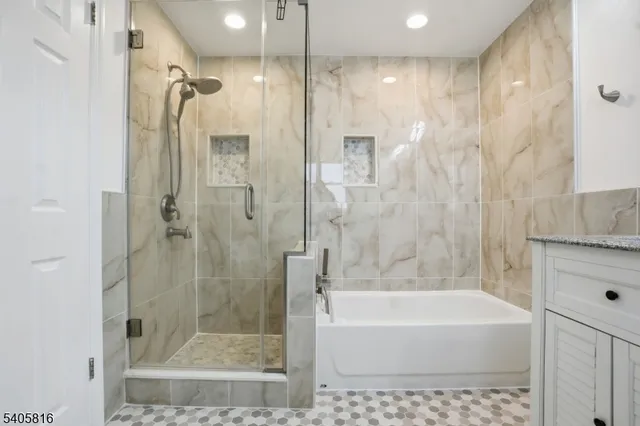 a bathroom with a bathtub and a shower
