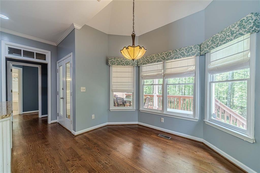 395 Amberbrook Circle Grayson, GA 30017 - Photo 18 of 70 a view of an empty room with a window and wooden floor