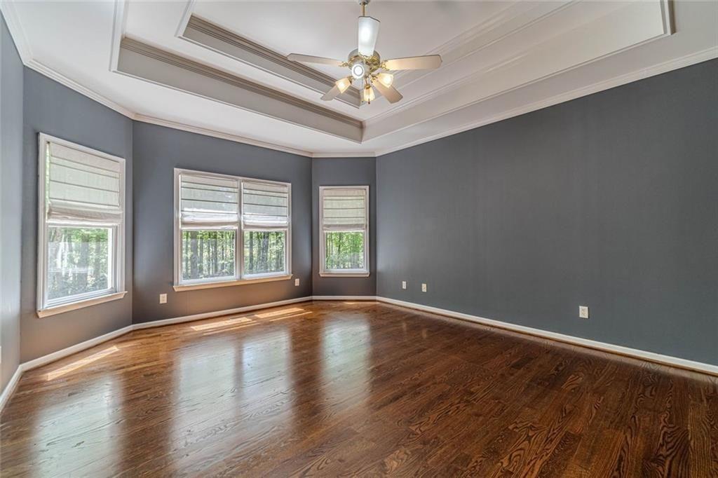 395 Amberbrook Circle Grayson, GA 30017 - Photo 20 of 70 a view of an empty room with window and wooden floor