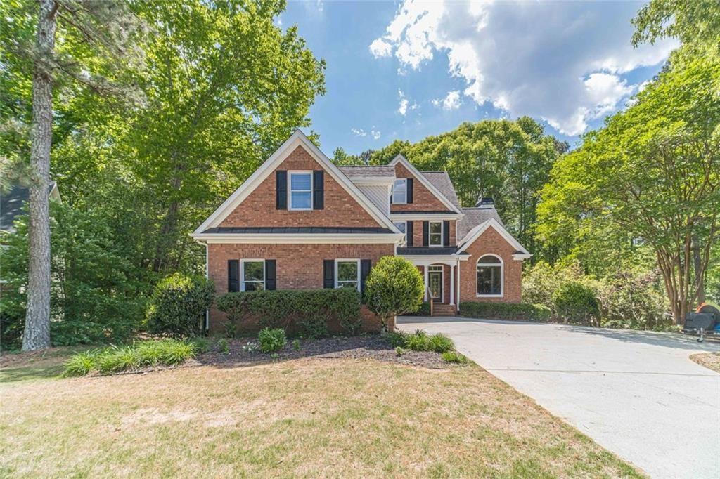 395 Amberbrook Circle Grayson, GA 30017 - Photo 2 of 70 a front view of a house with a yard and trees
