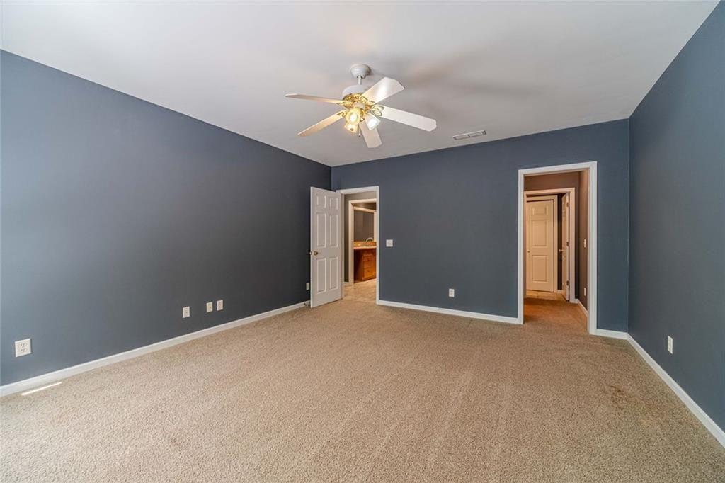 395 Amberbrook Circle Grayson, GA 30017 - Photo 40 of 70 a view of an empty room with window and chandelier fan