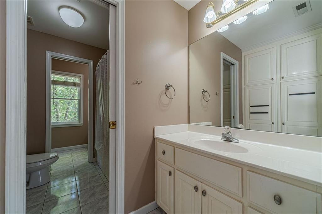 395 Amberbrook Circle Grayson, GA 30017 - Photo 46 of 70 a bathroom with a sink and a mirror