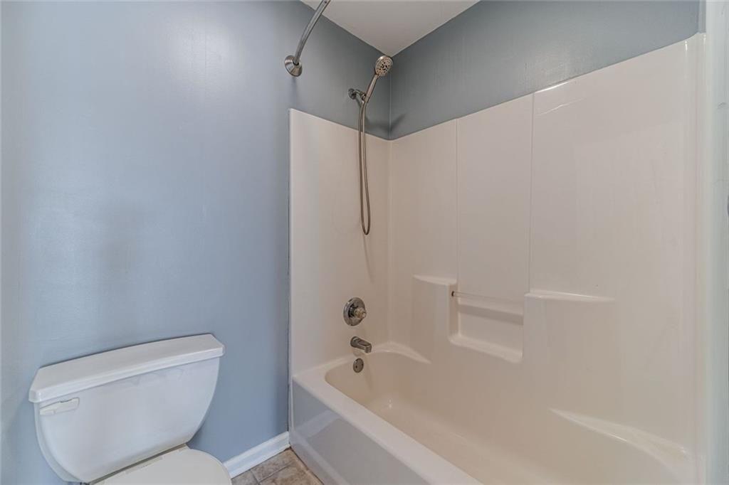 395 Amberbrook Circle Grayson, GA 30017 - Photo 47 of 70 a bathroom with a toilet and a bathtub