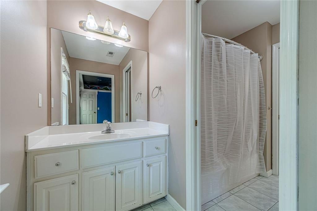 395 Amberbrook Circle Grayson, GA 30017 - Photo 48 of 70 a bathroom with a sink and a mirror