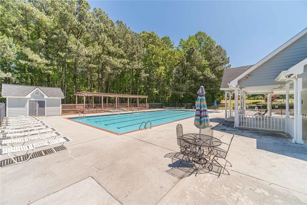 395 Amberbrook Circle Grayson, GA 30017 - Photo 62 of 70 a view of a patio with a table and chairs and potted plants