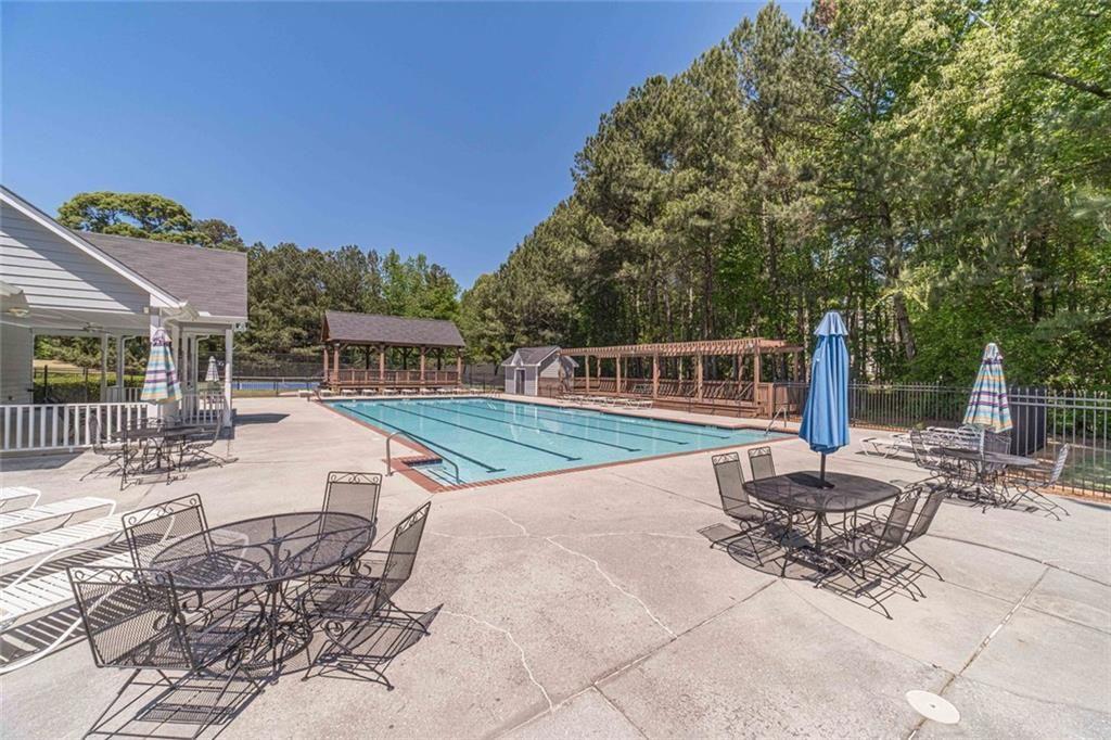 395 Amberbrook Circle Grayson, GA 30017 - Photo 63 of 70 a view of a patio with a table and chairs
