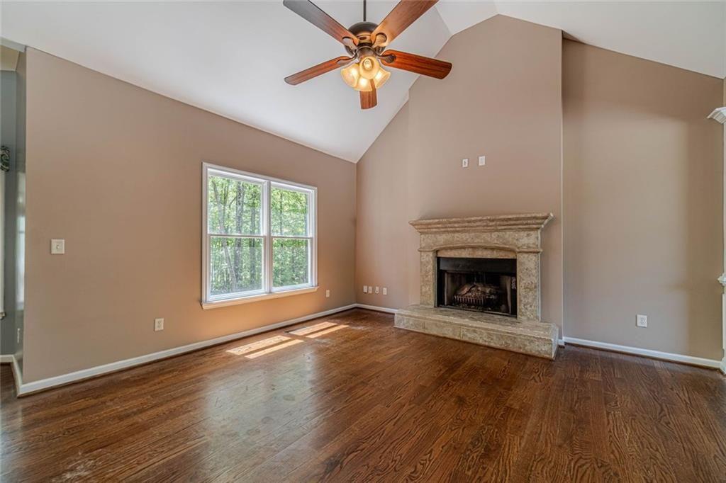 395 Amberbrook Circle Grayson, GA 30017 - Photo 8 of 70 wooden floor fireplace and natural light in room