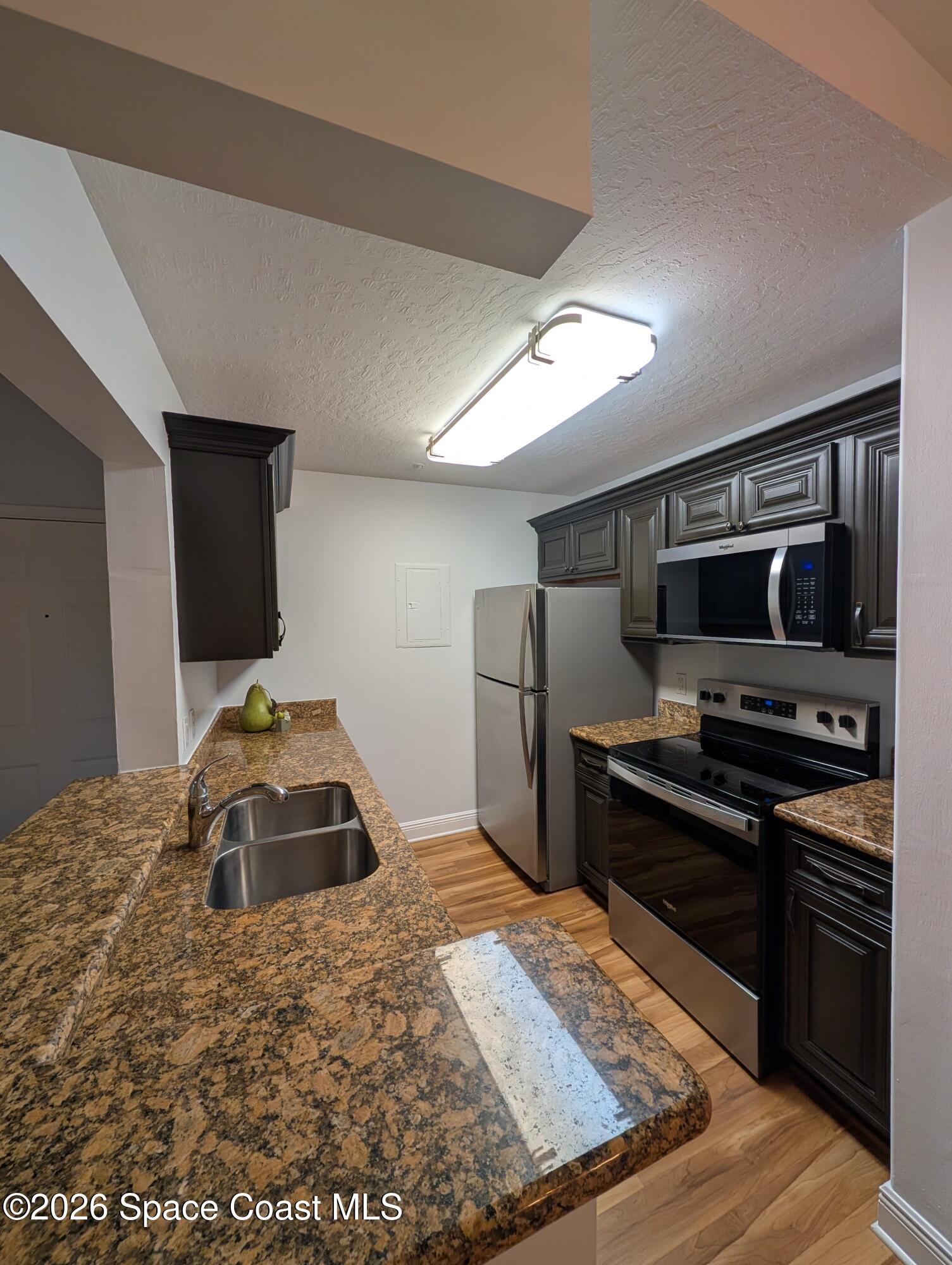 7667 North Wickham Road, Unit 818 Melbourne, FL 32940 - Photo 8 of 29 a bedroom with a bed and a television