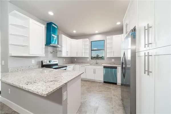 a kitchen with a sink stove and refrigerator