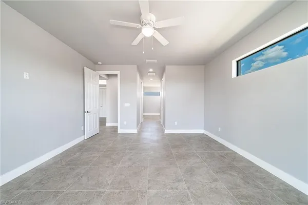 a view of an empty room with a ceiling fan