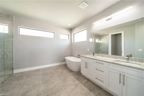 a bathroom with a double vanity sink toilet and a mirror