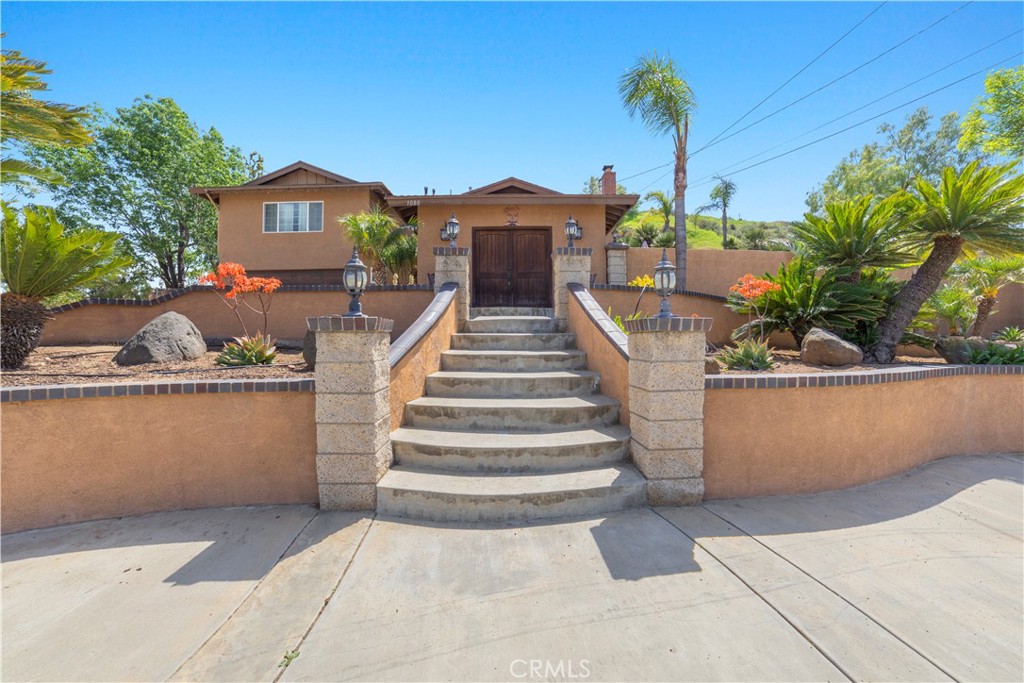 1080 First Street Norco, CA 92860 - Photo 2 of 36 a front view of a house with a yard