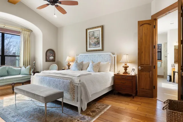 a bedroom with a bed and a chandelier