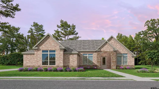 a front view of a house with a yard and potted plants