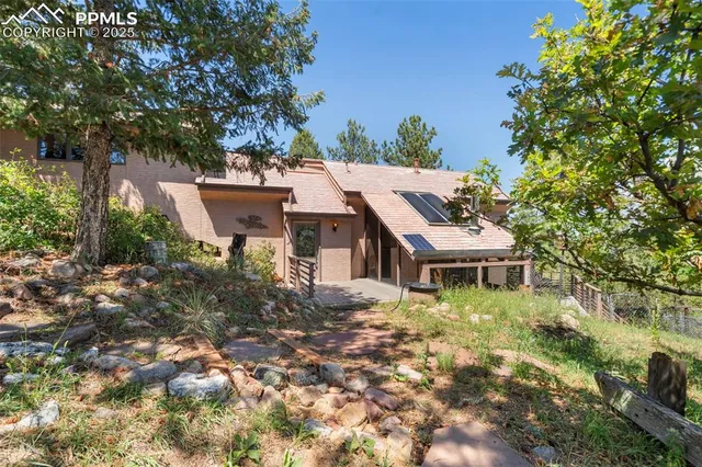 a aerial view of a house with a yard table and chairs