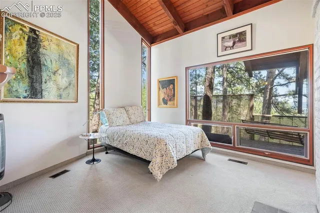 a bedroom with a bed and a large window