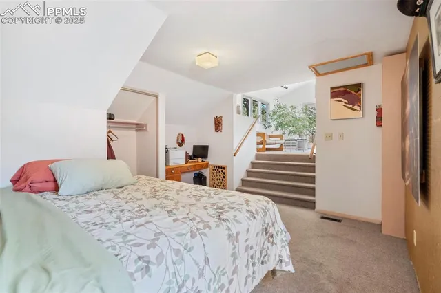 a bedroom with a bed and wall painting