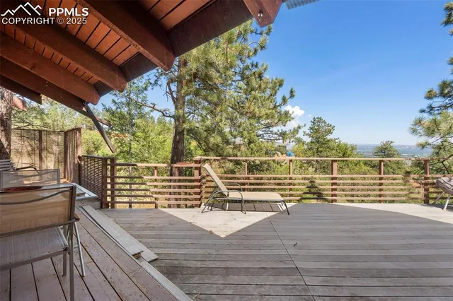 a balcony with wooden floor and furniture