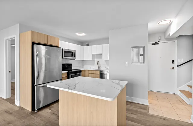 a kitchen with stainless steel appliances a refrigerator and a stove top oven