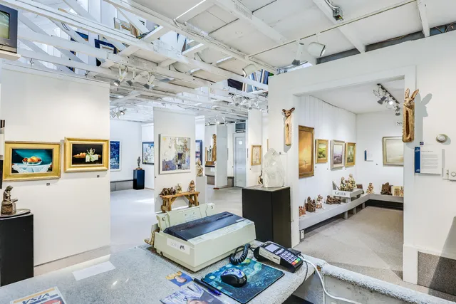 a room with furniture and paintings on the wall