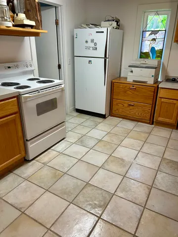a kitchen with a sink and a refrigerator