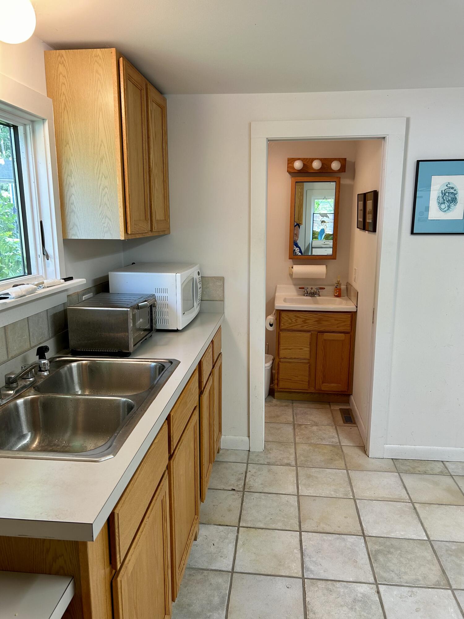 20 Bank Street Wellfleet, MA 02667 - Photo 26 of 49 a kitchen with a sink and a refrigerator