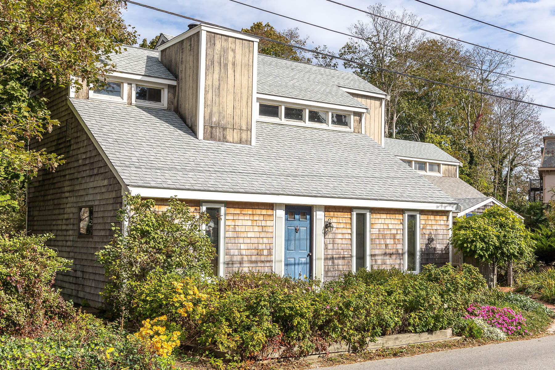 20 Bank Street Wellfleet, MA 02667 - Photo 34 of 49 a front view of a house with a yard