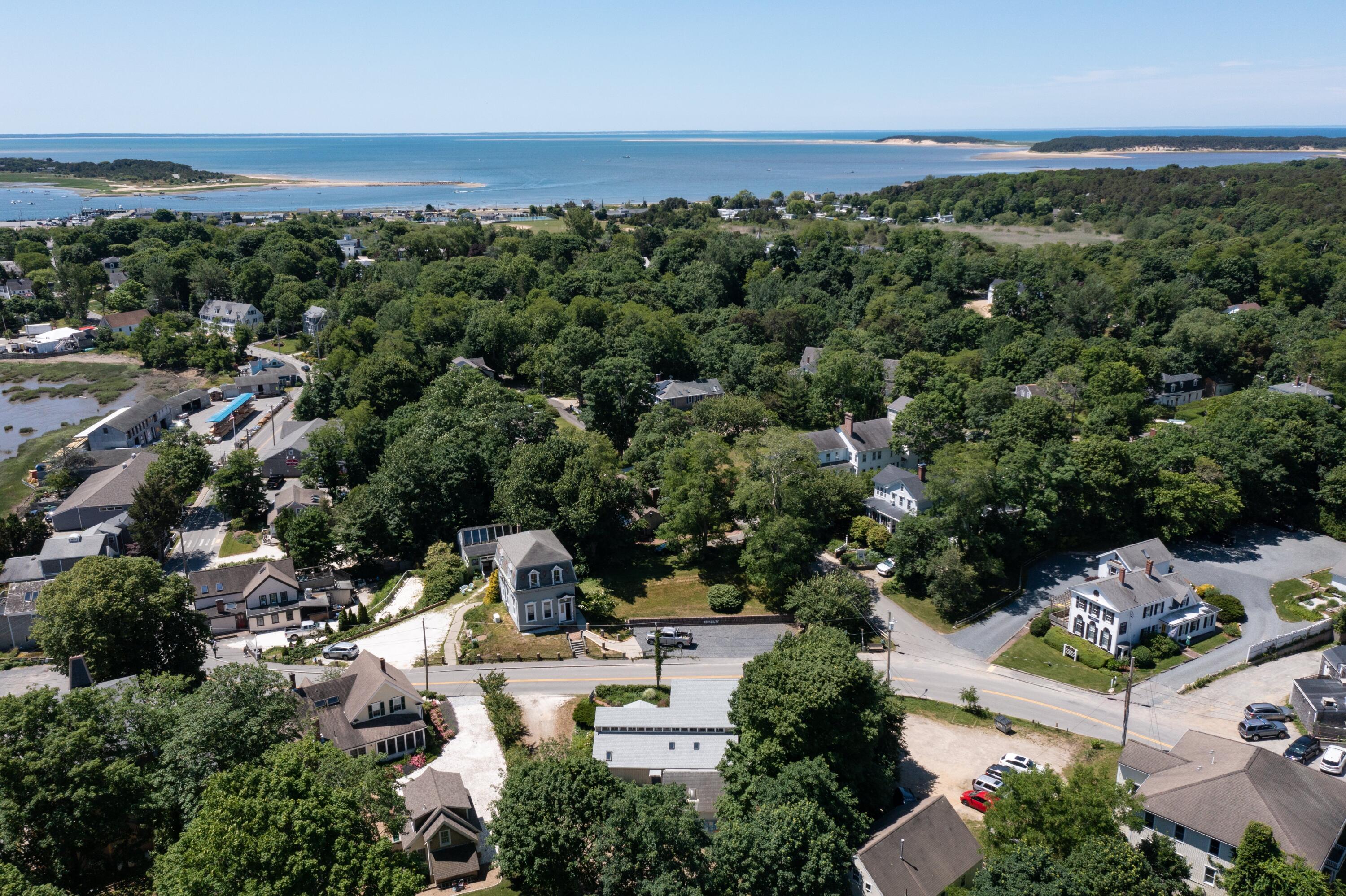 20 Bank Street Wellfleet, MA 02667 - Photo 39 of 49 an aerial view of a city with lots of residential buildings ocean and mountain view in back
