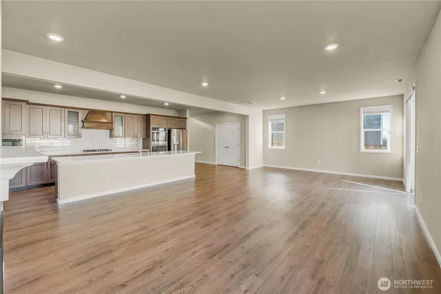 a view of a kitchen with a sink and wooden floor