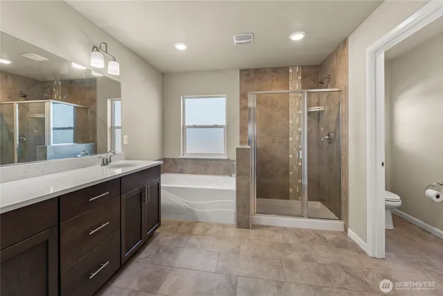a bathroom with a double vanity sink toilet and shower