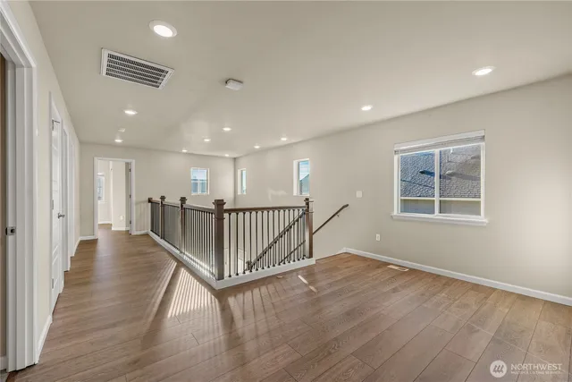 a view of a hallway with wooden floor