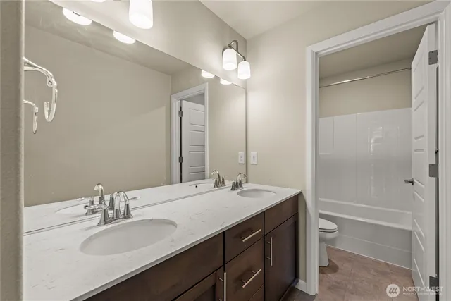 a bathroom with a sink double vanity and a mirror