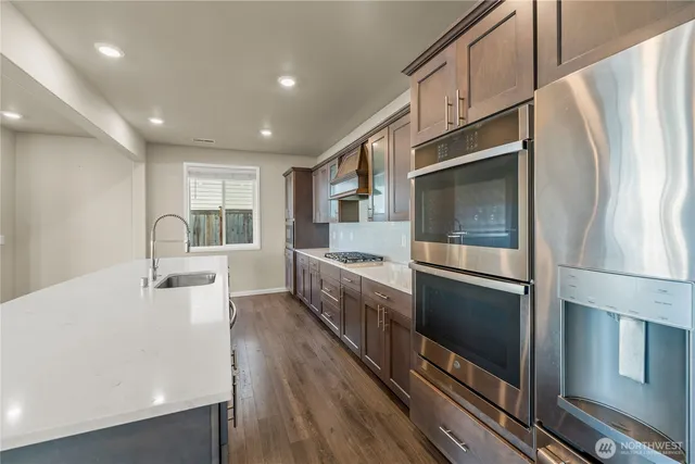 a kitchen with stainless steel appliances a refrigerator and a stove