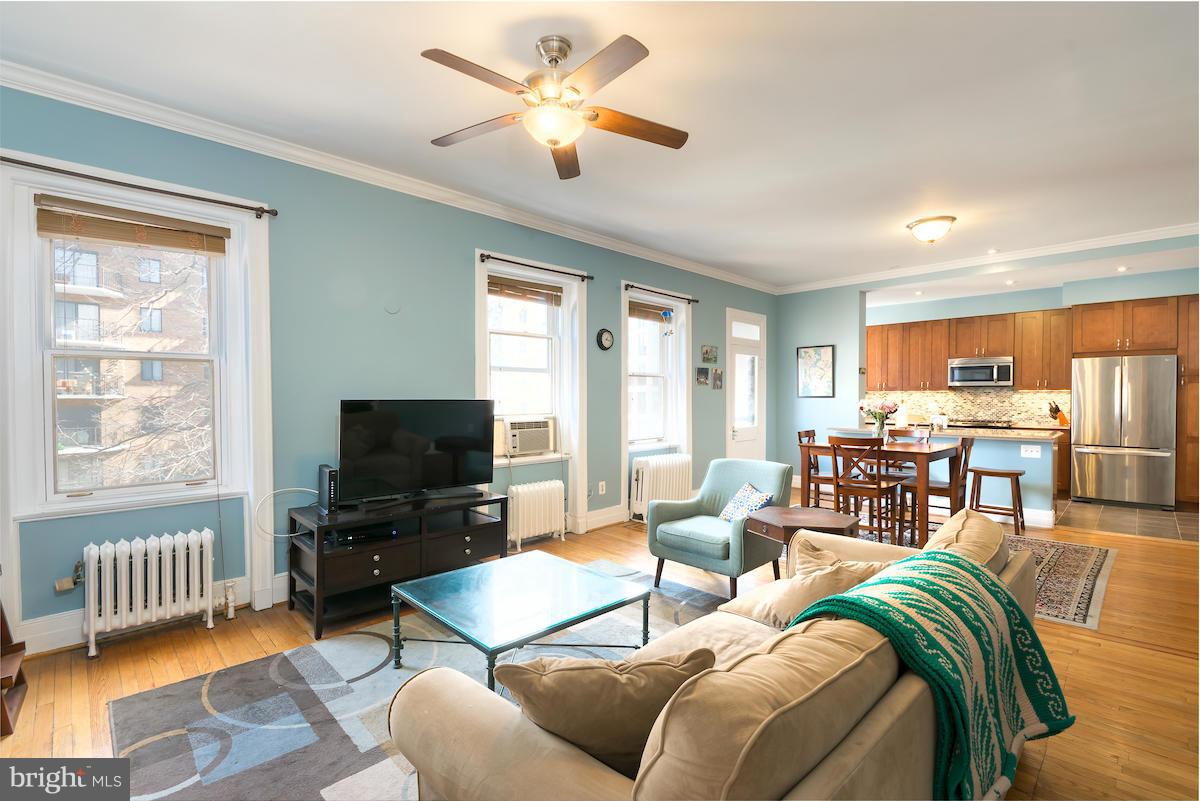 1734 P Street Northwest, Unit 46 Washington, DC 20036 - Photo 2 of 16 a living room with furniture a ceiling fan and a window