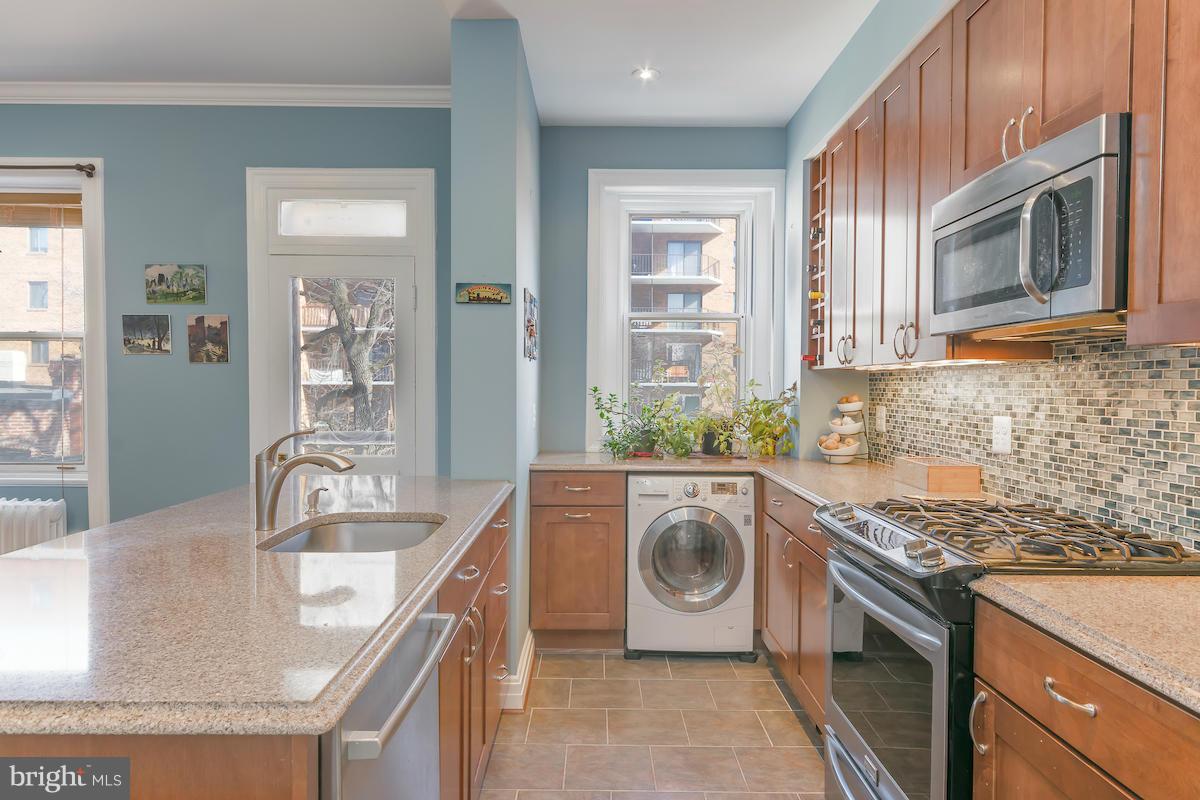 1734 P Street Northwest, Unit 46 Washington, DC 20036 - Photo 11 of 16 a kitchen with a sink stove and washer