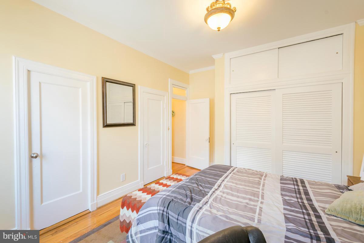 1734 P Street Northwest, Unit 46 Washington, DC 20036 - Photo 14 of 16 a bedroom with a bed and a chandelier