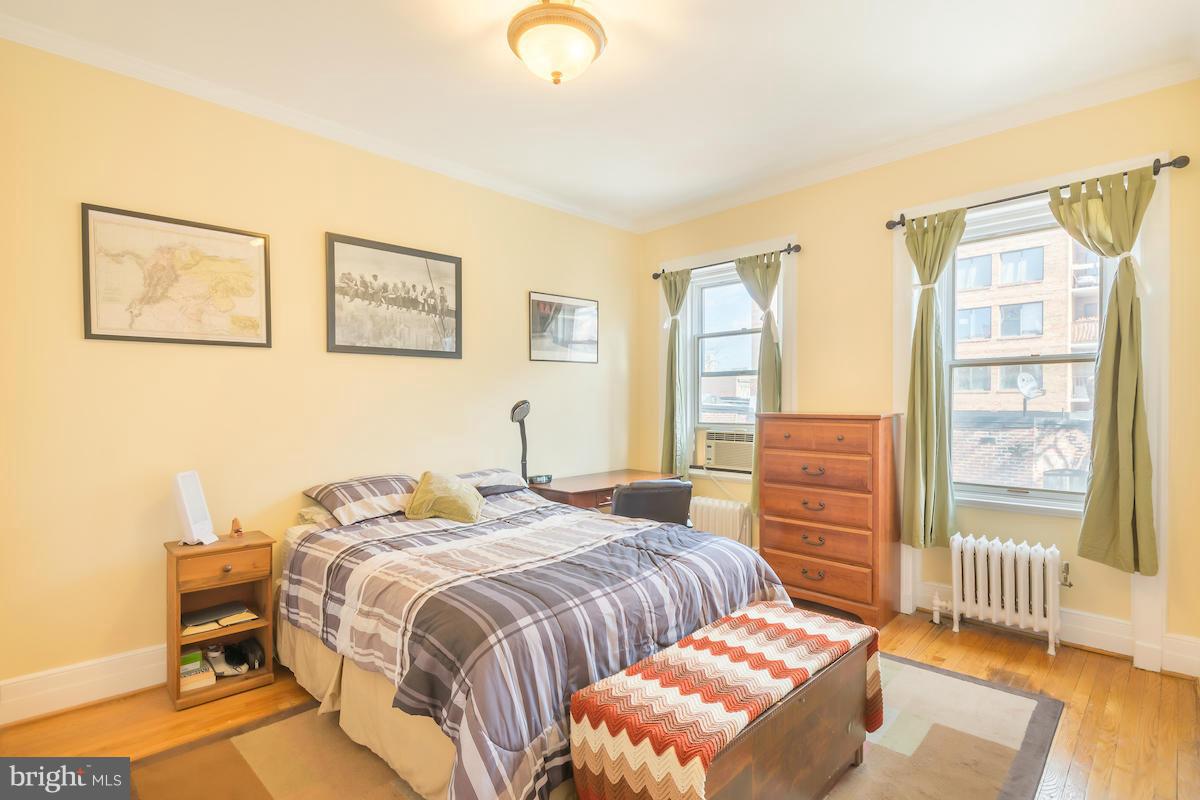 1734 P Street Northwest, Unit 46 Washington, DC 20036 - Photo 15 of 16 a bedroom with a bed and wooden floor