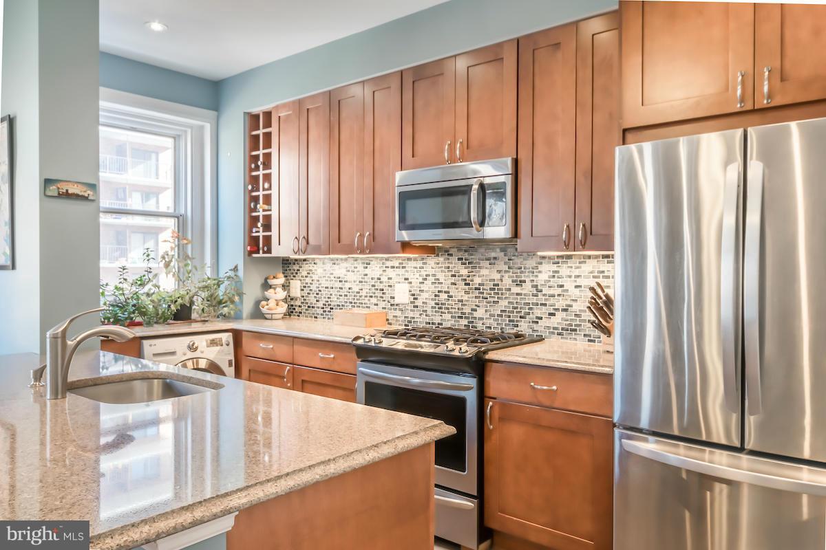 1734 P Street Northwest, Unit 46 Washington, DC 20036 - Photo 10 of 16 a kitchen with appliances a sink and a counter top space