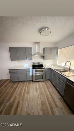 a kitchen with kitchen island granite countertop white cabinets and stainless steel appliances