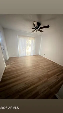 a view of a room with wooden floor