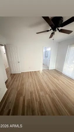 a view of a room with wooden floor