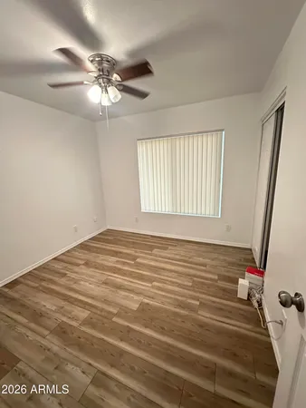 a view of a livingroom with an empty space & a ceiling fan