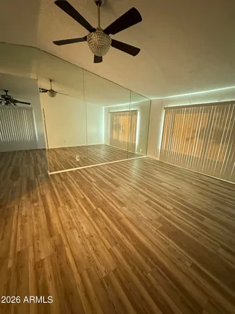 a view of an empty room with wooden floor