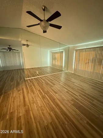 a view of a room with wooden floor
